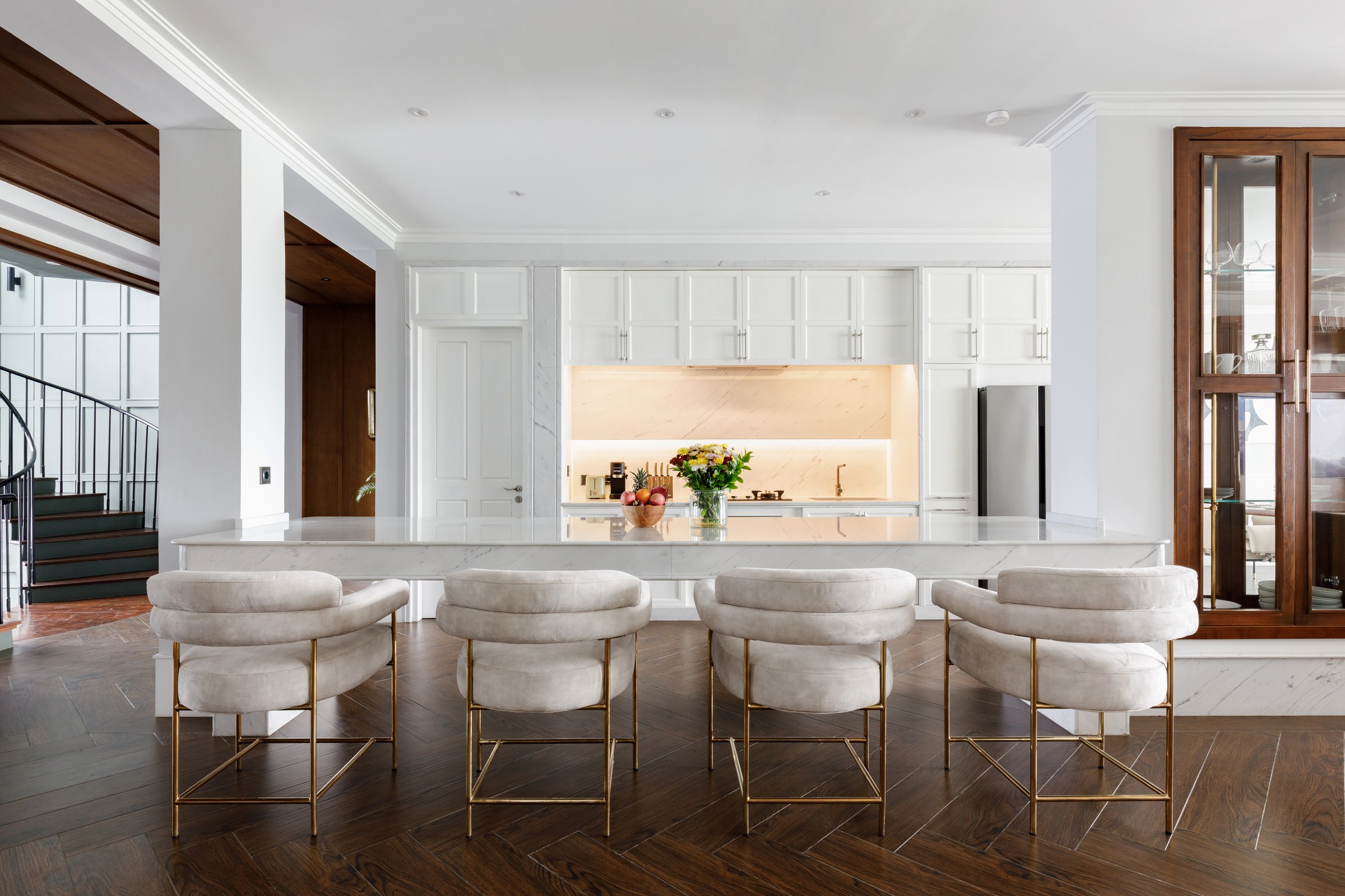 Kitchen island with gold stools at Mayfair Place
